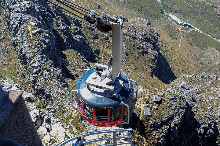 Experience the stunning journey as the cable car ascends Table Mountain offering a unique perspective on breathtaking views of Cape Town and its majestic landscape.